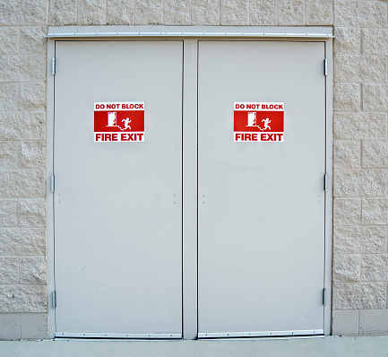 fire exit doors with international emergency pictogram symbol