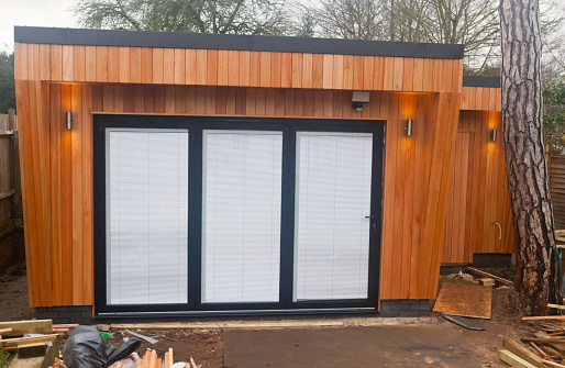 western red cedar clad home garden office with bifold doors nearing construction completion