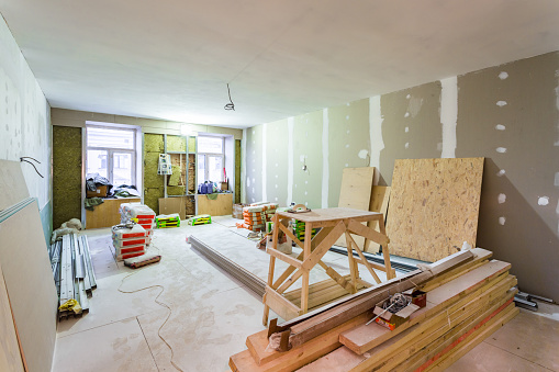 working process of installing metal frames for plasterboard drywall for making gypsum walls in apartment is under construction, remodeling, renovation, extension, restoration and reconstruction.