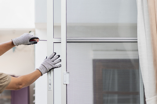 construction worker repairing the sliding window.