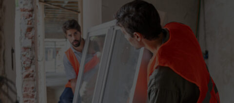 construction workers installing new window in building